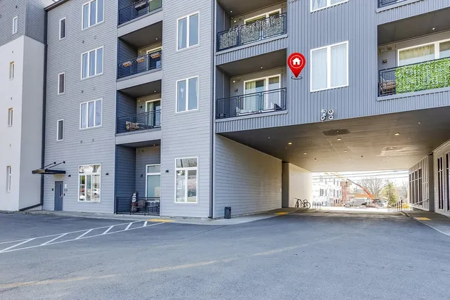 a view of a building with car parked