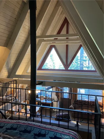 a bedroom with bed and mirror