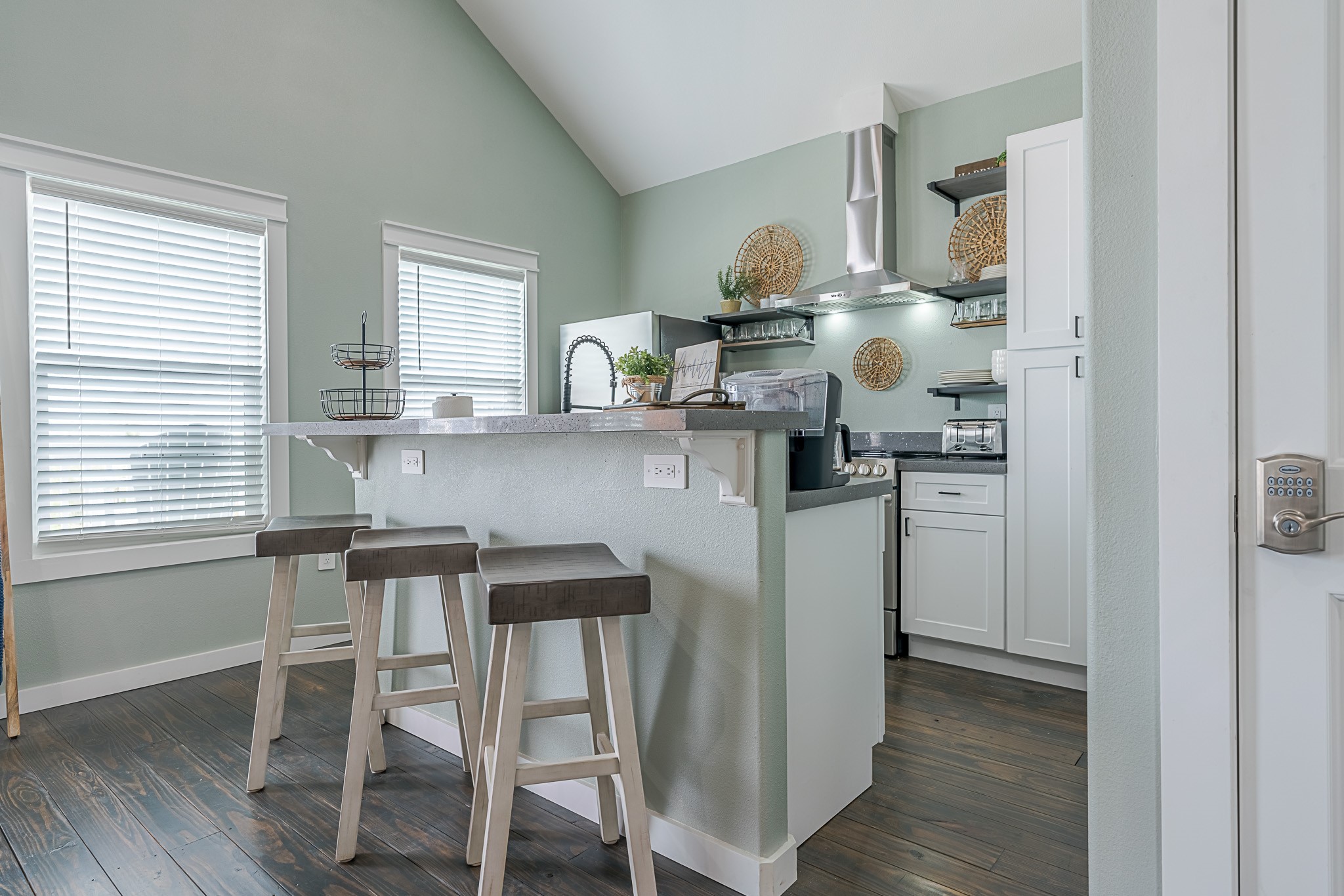 1057 Johnson Road Port Bolivar, TX 77650 - Photo 12 of 40 Your kitchen makes the most of its space with stainless appliances, ample cabinetry, open shelving, and bar seating for casual meals.