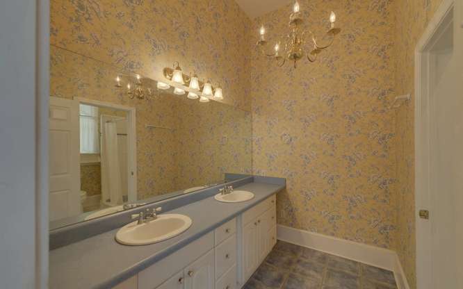 330 River Road Westminster, SC 29693 - Photo 18 of 45 Double vanities and an elegant chandelier create a spacious and well-lit private bath.