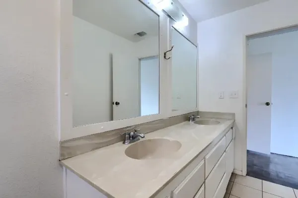 a bathroom with a sink vanity granite and a mirror