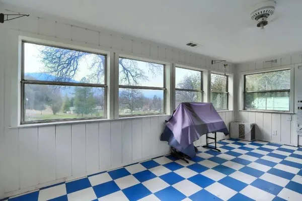 a view of a room with a black and white checkered floor