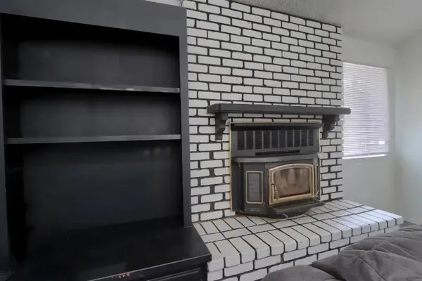 a bedroom with a bed and a fireplace