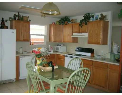 a kitchen with a table and chairs