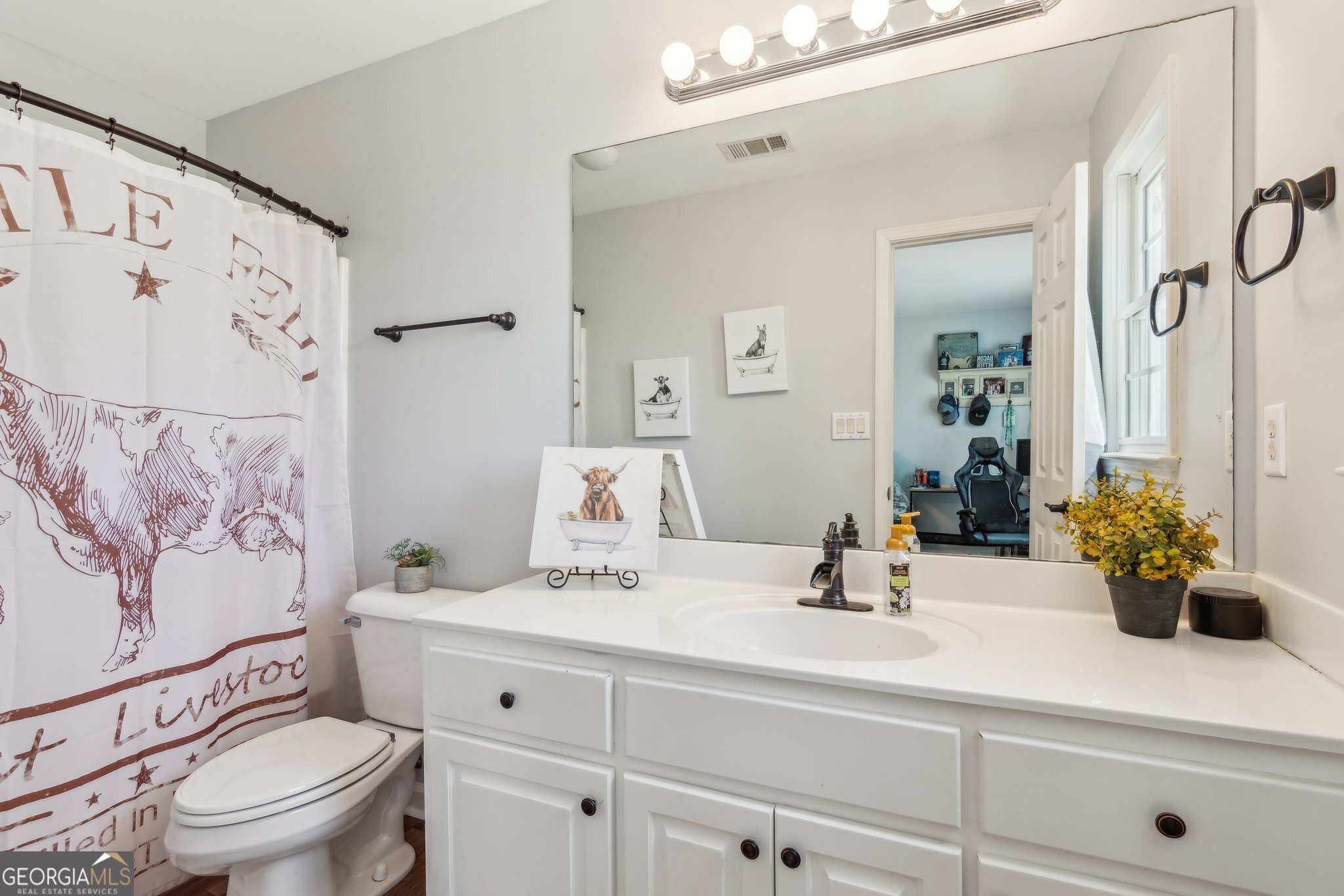 5388 Frazer Road Buford, GA 30518 - Photo 31 of 100 a bathroom with a sink a toilet and a large mirror