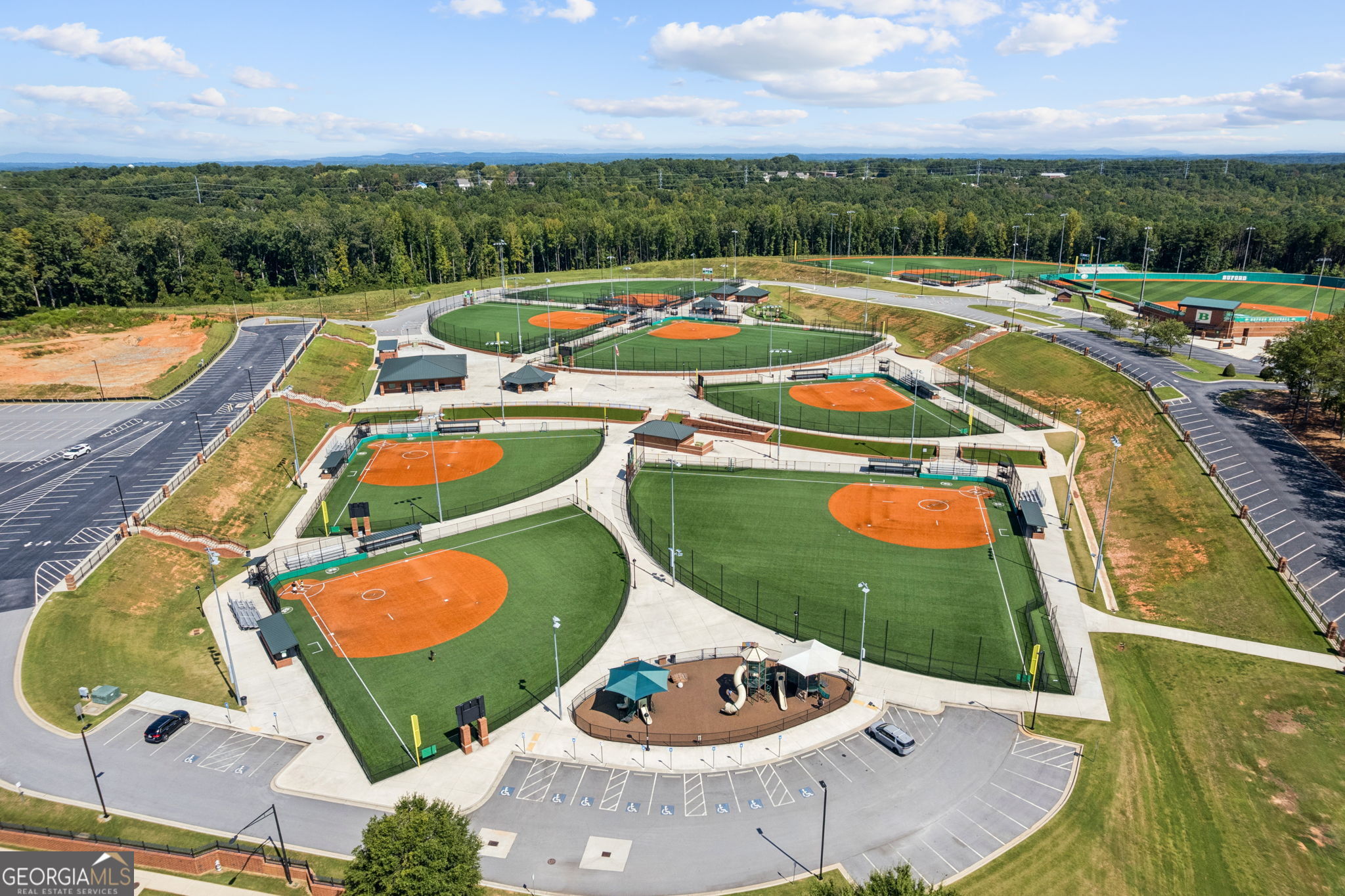 5388 Frazer Road Buford, GA 30518 - Photo 96 of 100 a view of swimming pool with seating space and trees in the background