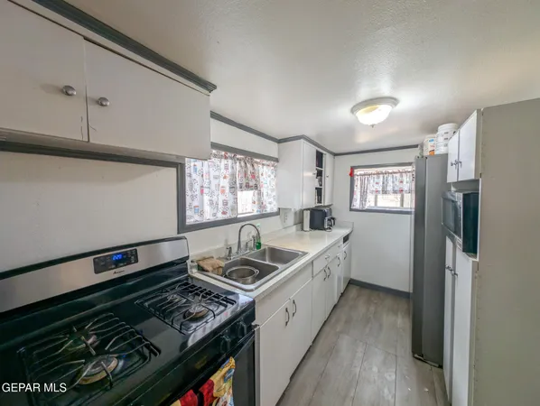 a kitchen that has a sink and a stove