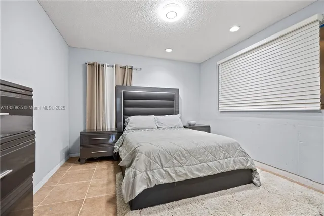 a bedroom with a bed and a night stand