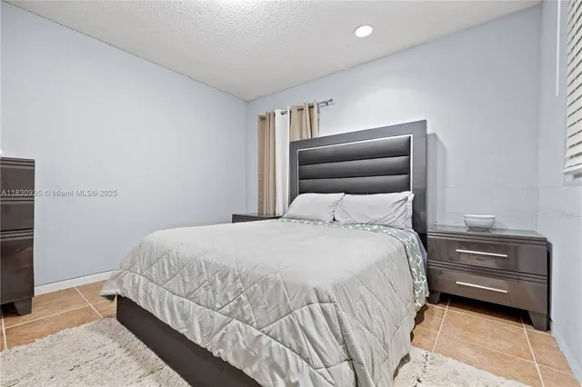 a bedroom with two beds and window