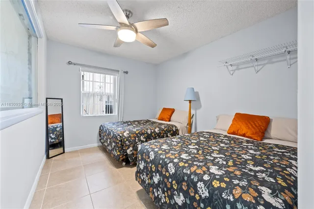 a bedroom with two beds and a chandelier