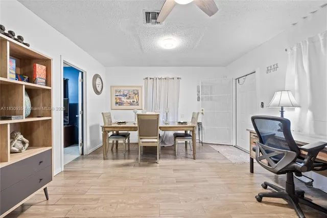 a living room with furniture a fireplace and a chandelier