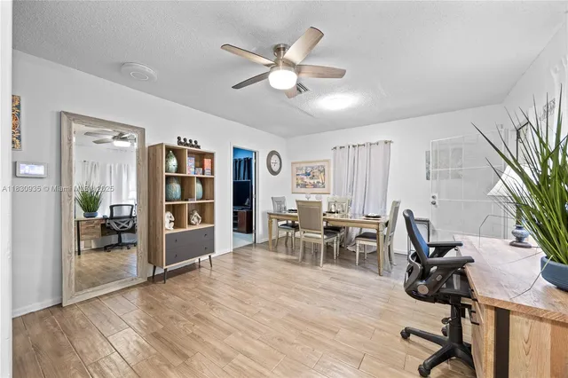 a view of a dining room with furniture and wooden floor