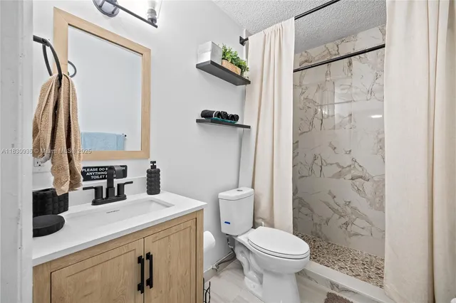 a bedroom with two beds and painting on the wall