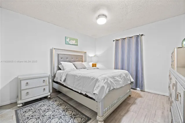 a bedroom with a bed and a large mirror