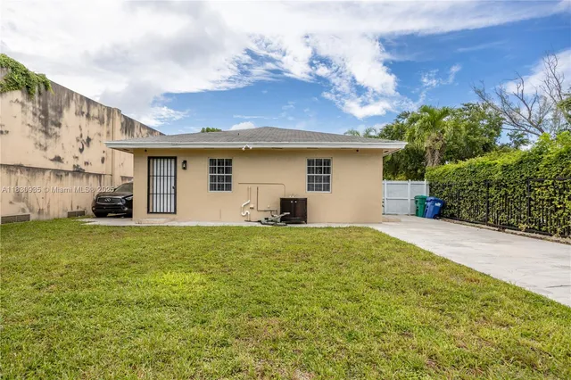 a view of garage and wooden fence