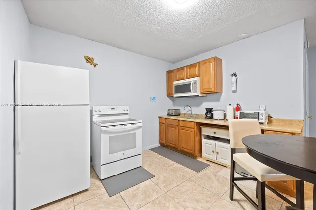 a view of a dining room with furniture and a chandelier