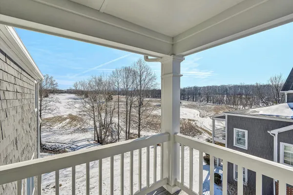 a dining hall with stainless steel appliances kitchen island granite countertop a table and chairs