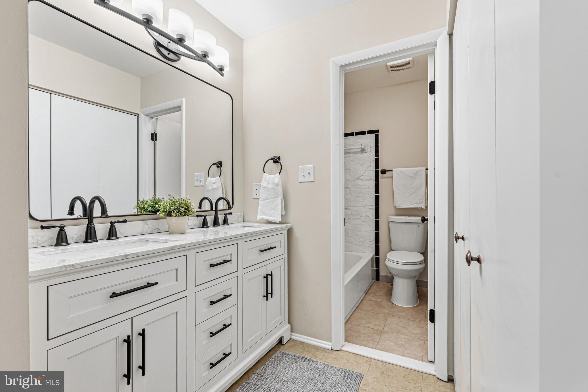 9 Menteith Court Baltimore, MD 21236 - Photo 23 of 46 a bathroom with a granite countertop sink vanity mirror and toilet