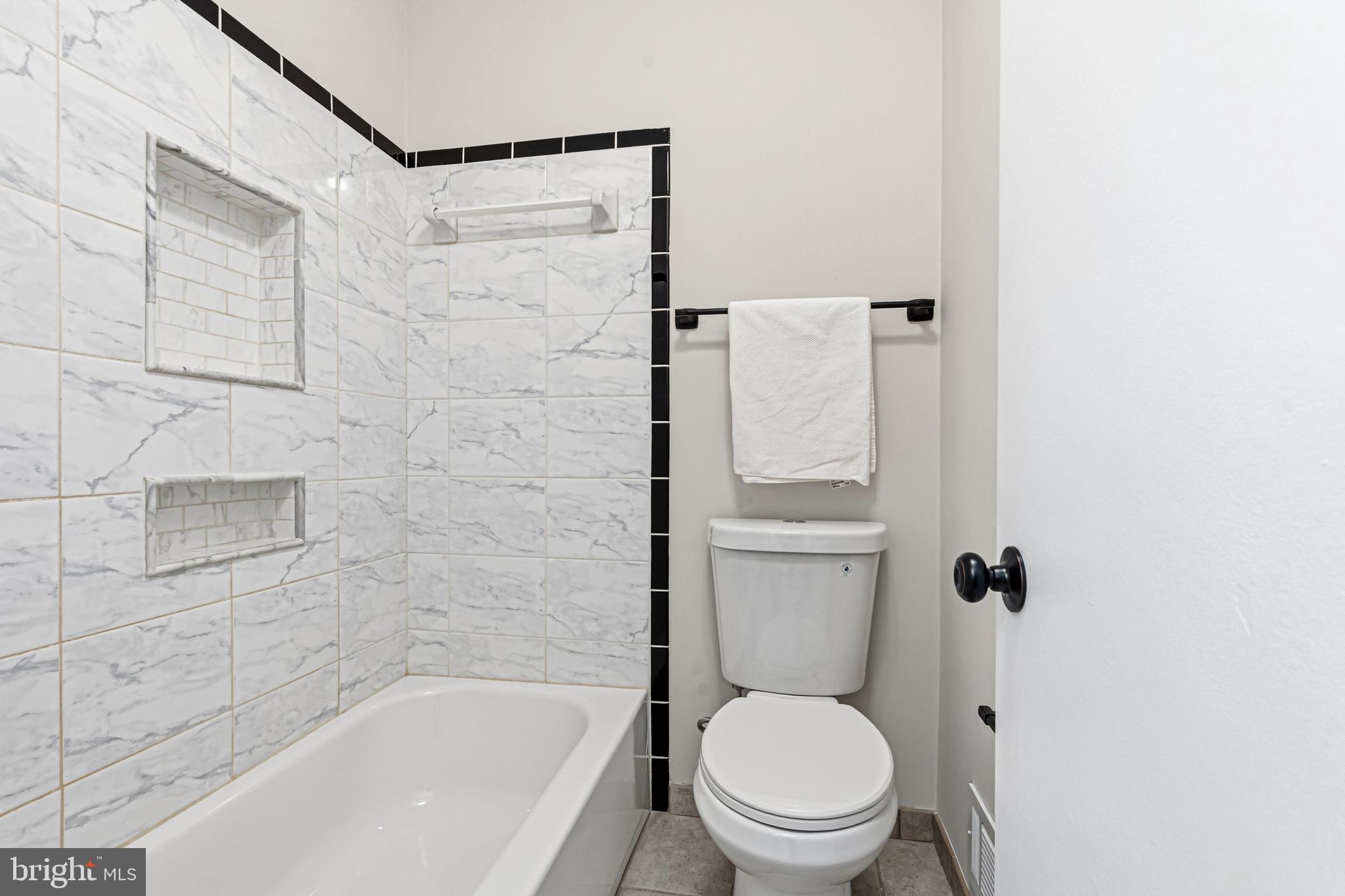 9 Menteith Court Baltimore, MD 21236 - Photo 24 of 46 a white toilet sitting next to a bath tub