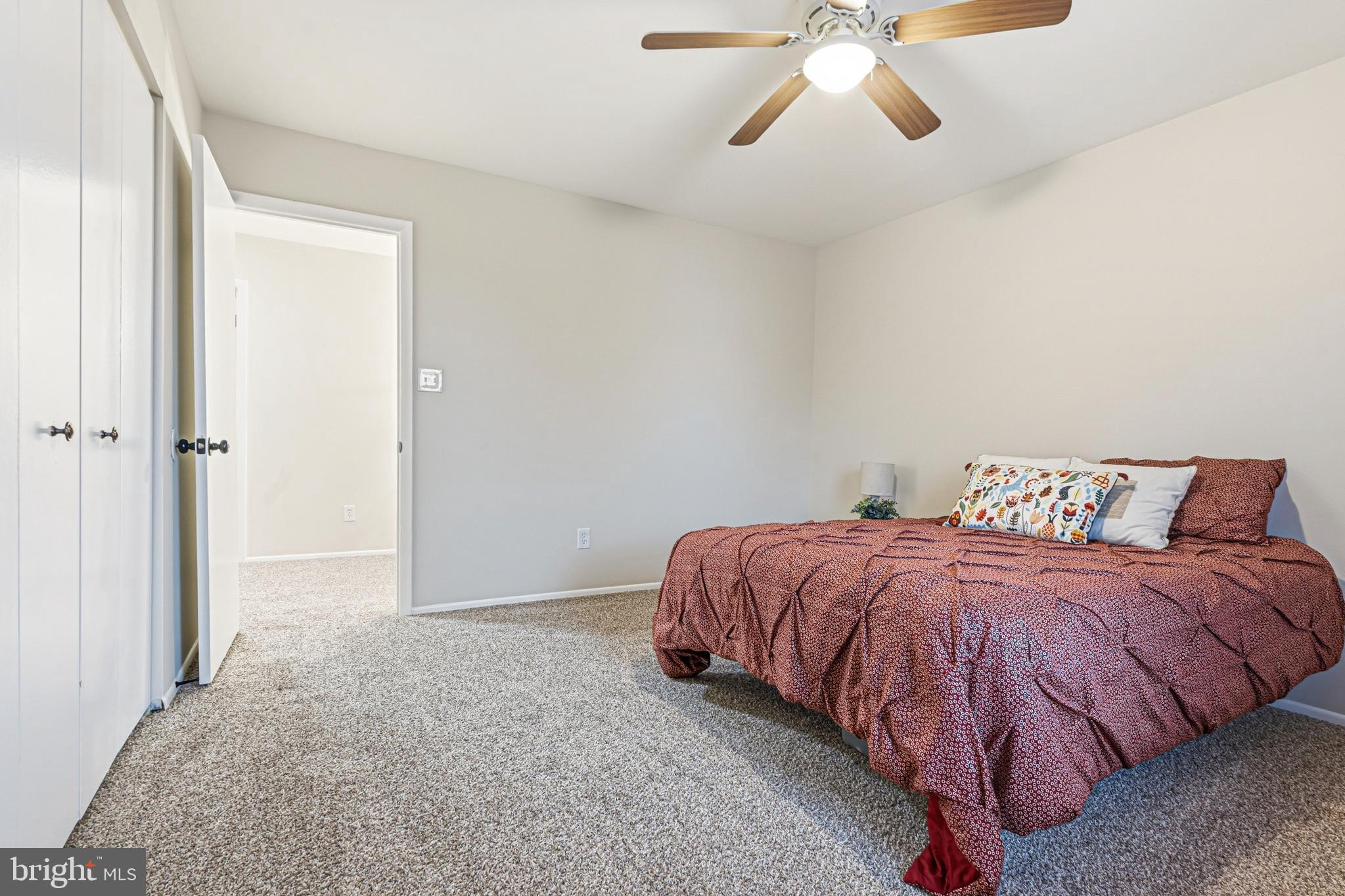 9 Menteith Court Baltimore, MD 21236 - Photo 26 of 46 a spacious bedroom with a bed and a chandelier