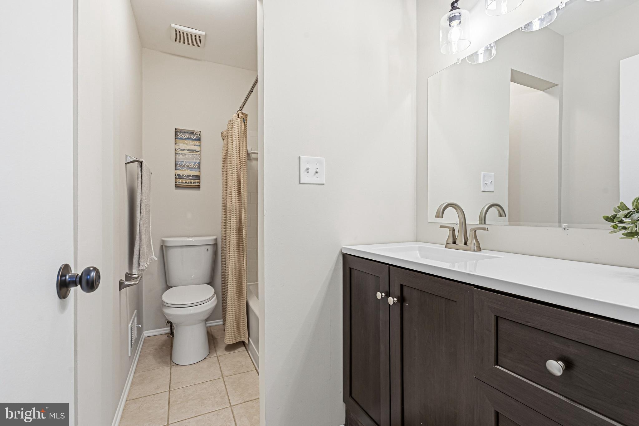 9 Menteith Court Baltimore, MD 21236 - Photo 27 of 46 a bathroom with a sink toilet and shower