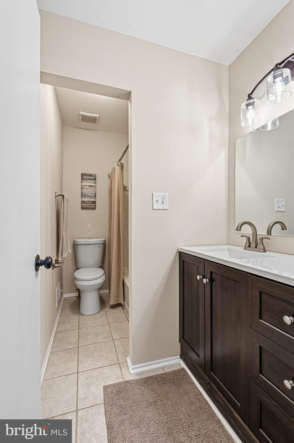 9 Menteith Court Baltimore, MD 21236 - Photo 28 of 46 a spacious bathroom with a double vanity sink a toilet and a mirror