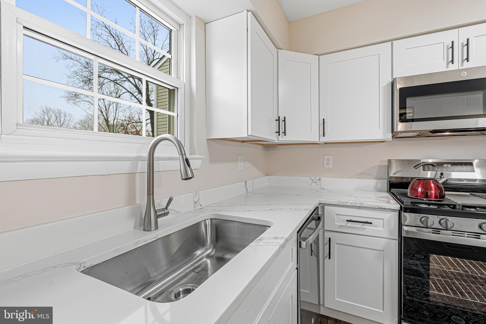 9 Menteith Court Baltimore, MD 21236 - Photo 9 of 46 a kitchen with stainless steel appliances granite countertop a sink and a stove top oven