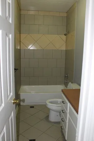 a bathroom with a sink a toilet and bathtub