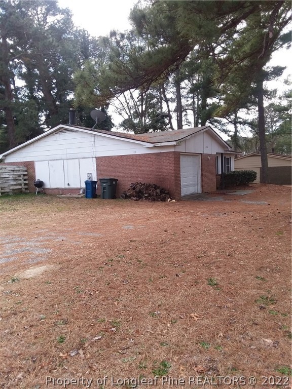 2560 Graham Road Fayetteville, NC 28304 - Photo 3 of 13 a view of a house with a yard and garage