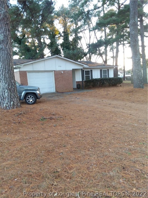 2560 Graham Road Fayetteville, NC 28304 - Photo 4 of 13 a view of a house with a large tree and a yard