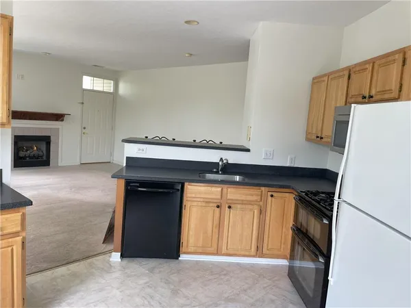 a kitchen with a refrigerator and a stove