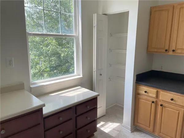 a room with a dresser and a window