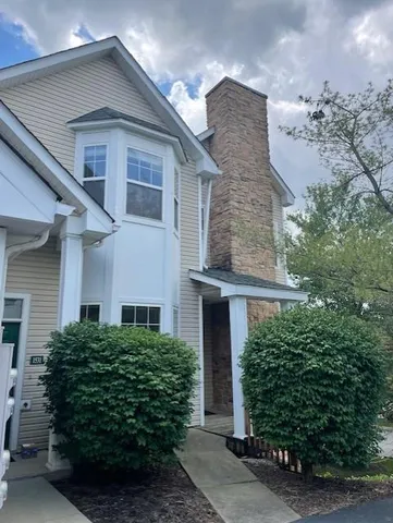 front view of a house with a garden