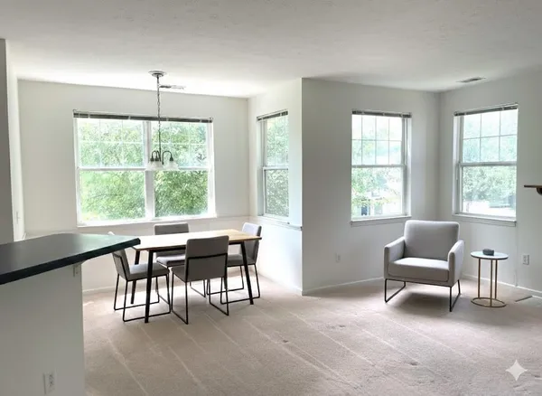 a view of a livingroom with furniture and a window