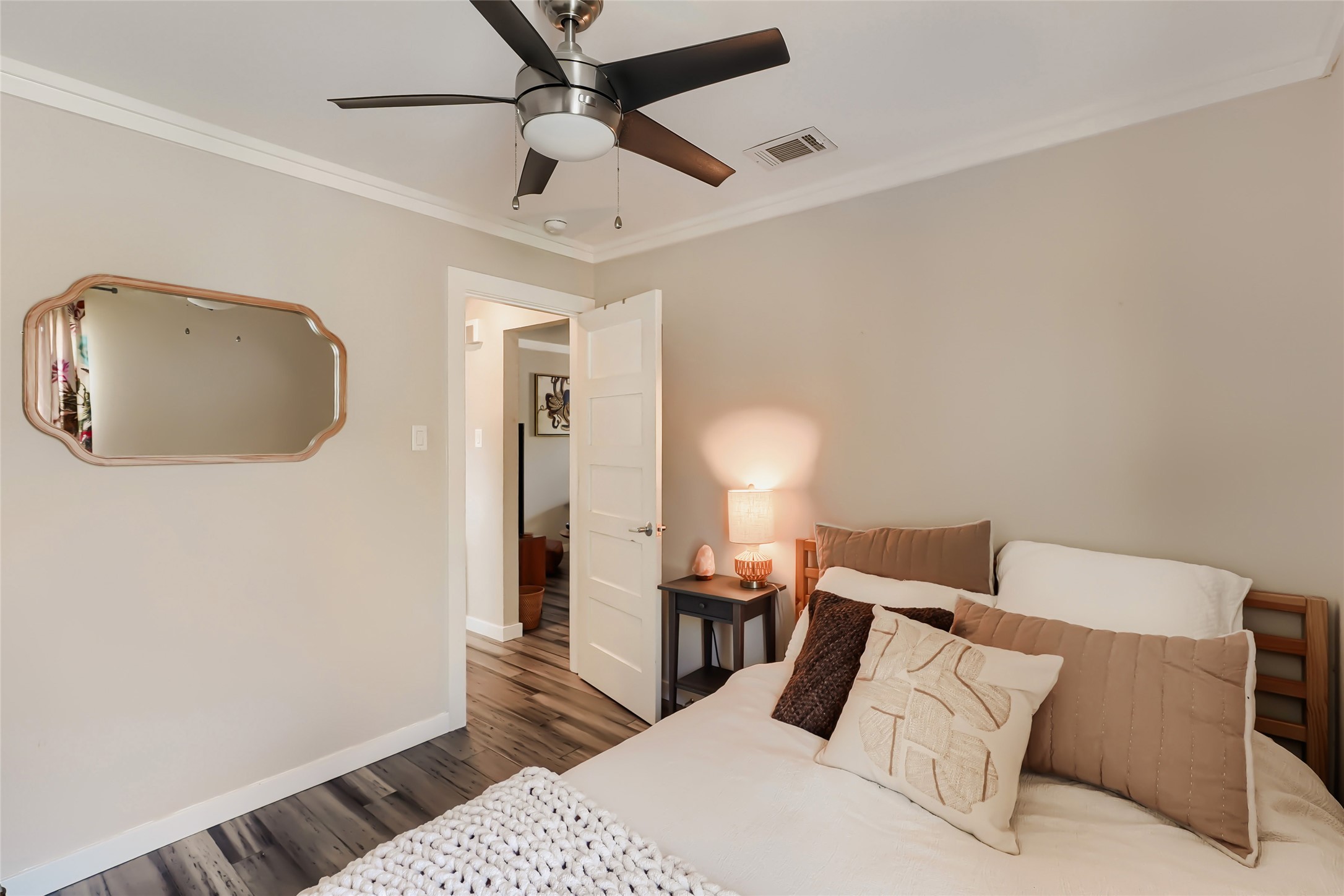 5707 Tracy Lynn Lane, Unit A Austin, TX 78721 - Photo 22 of 33 Bedroom featuring ornamental molding, dark wood-style flooring, and a ceiling fan