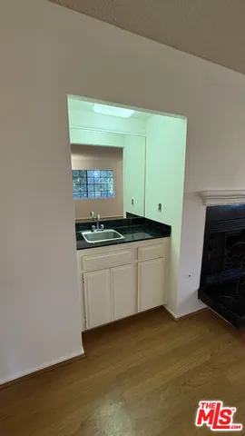 a white refrigerator freezer and a stove sitting inside of a kitchen