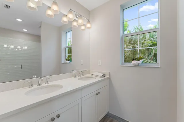 a bedroom with a bed window and a flat screen tv