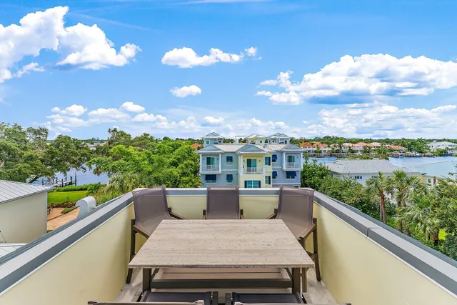 a view of a lake with a table and chairs