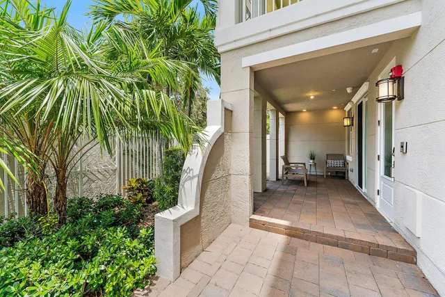 a view of an empty room with stairs and a ceiling fan