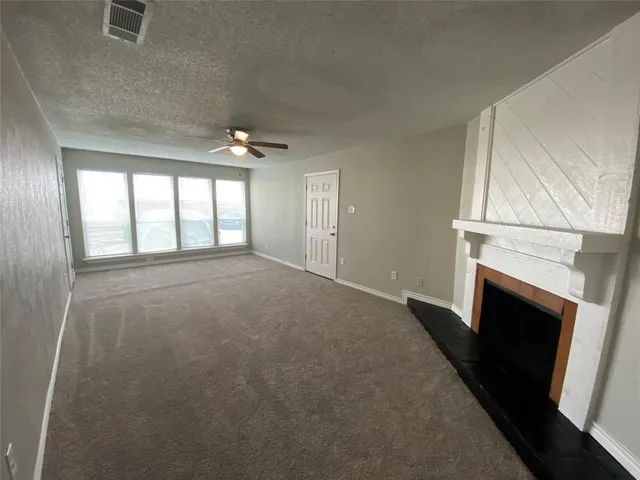 wooden floor in an empty room with a fireplace