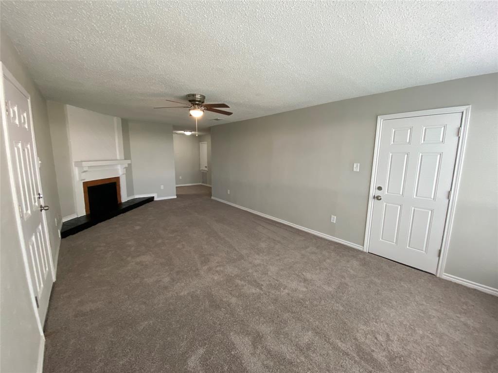 9696 Walnut Street, Unit 603 Dallas, TX 75243 - Photo 5 of 15 wooden floor in an empty room with a fireplace