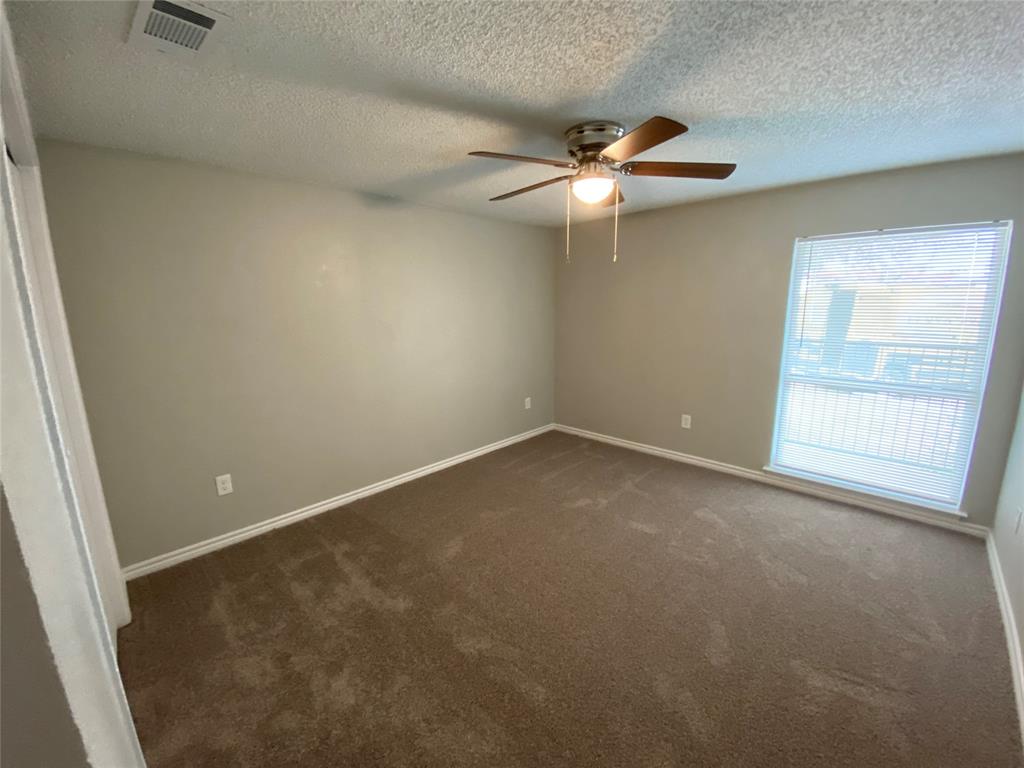 9696 Walnut Street, Unit 603 Dallas, TX 75243 - Photo 10 of 15 an empty room with a window and a fan