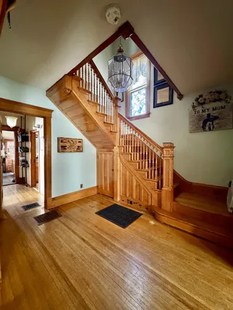 a view of staircase with white walls and a window