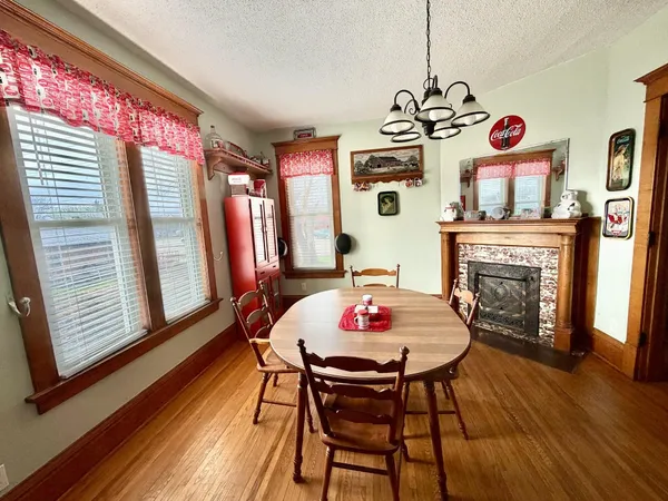 a view of a dining room with furniture wooden floor and chandelier