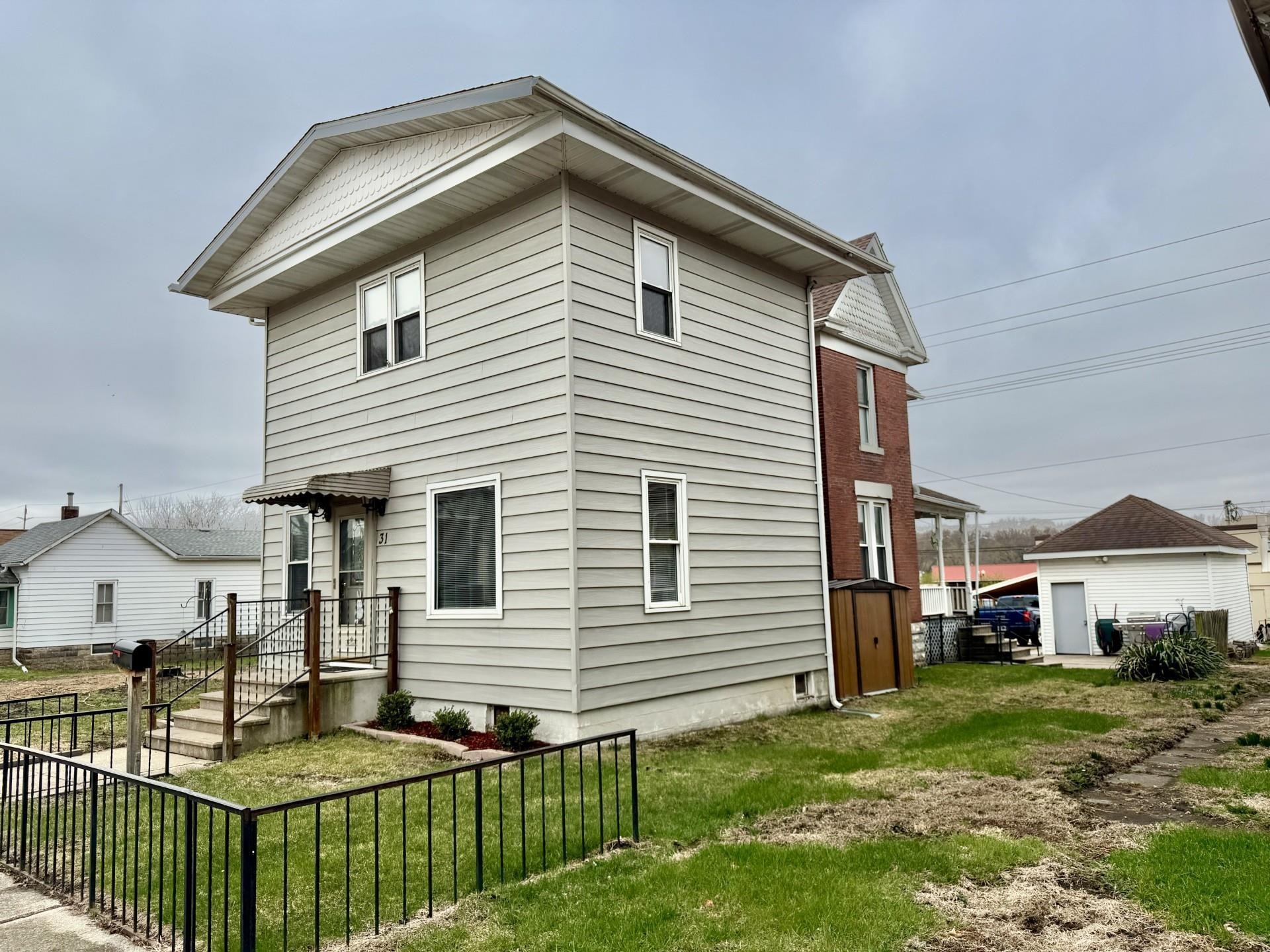 31 3rd Street Savanna, IL 61074 - Photo 2 of 42 a front view of a house with a yard
