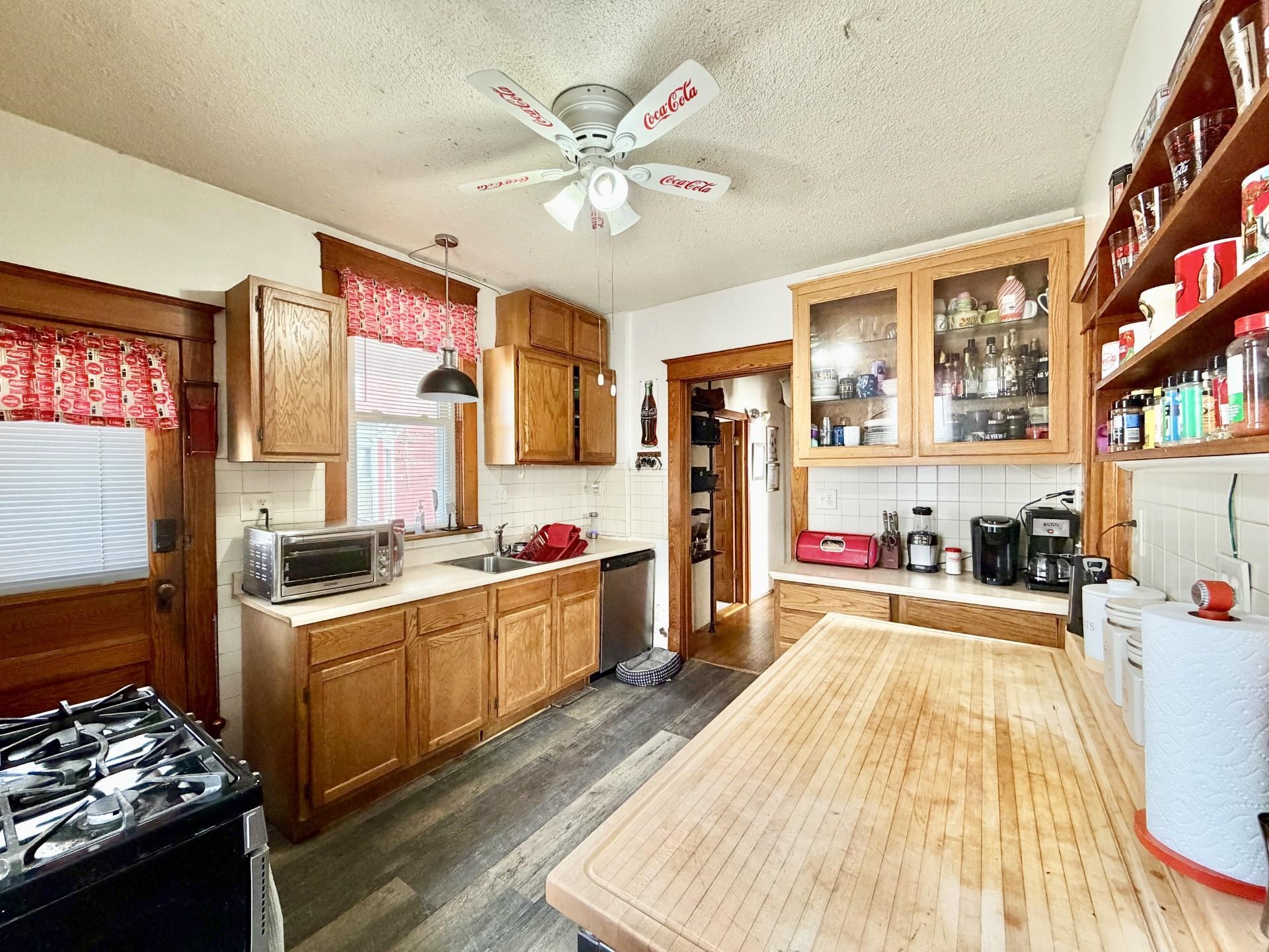 31 3rd Street Savanna, IL 61074 - Photo 25 of 42 a kitchen that has a lot of cabinets stainless steel appliances and a chandelier
