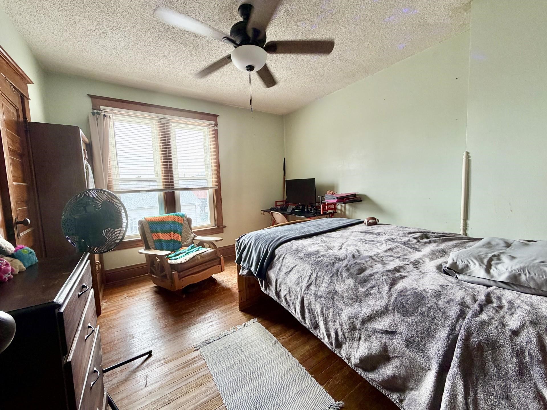31 3rd Street Savanna, IL 61074 - Photo 29 of 42 a bedroom with bed couch and window