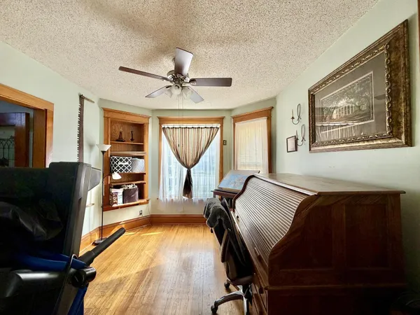 a living room with furniture gym equipment and a window