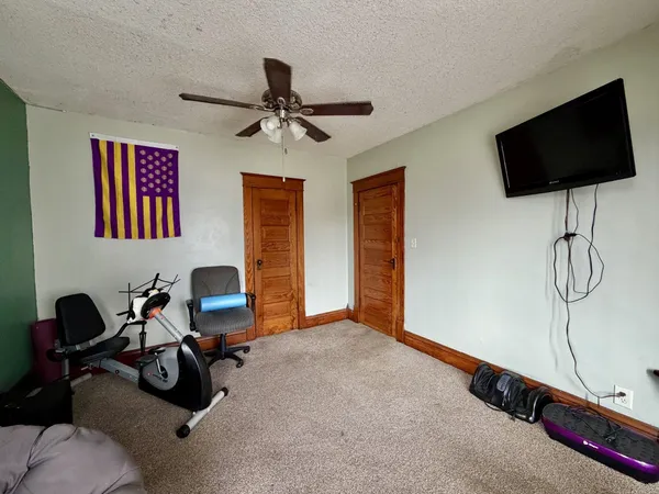 a view of a room with gym equipment and a large window