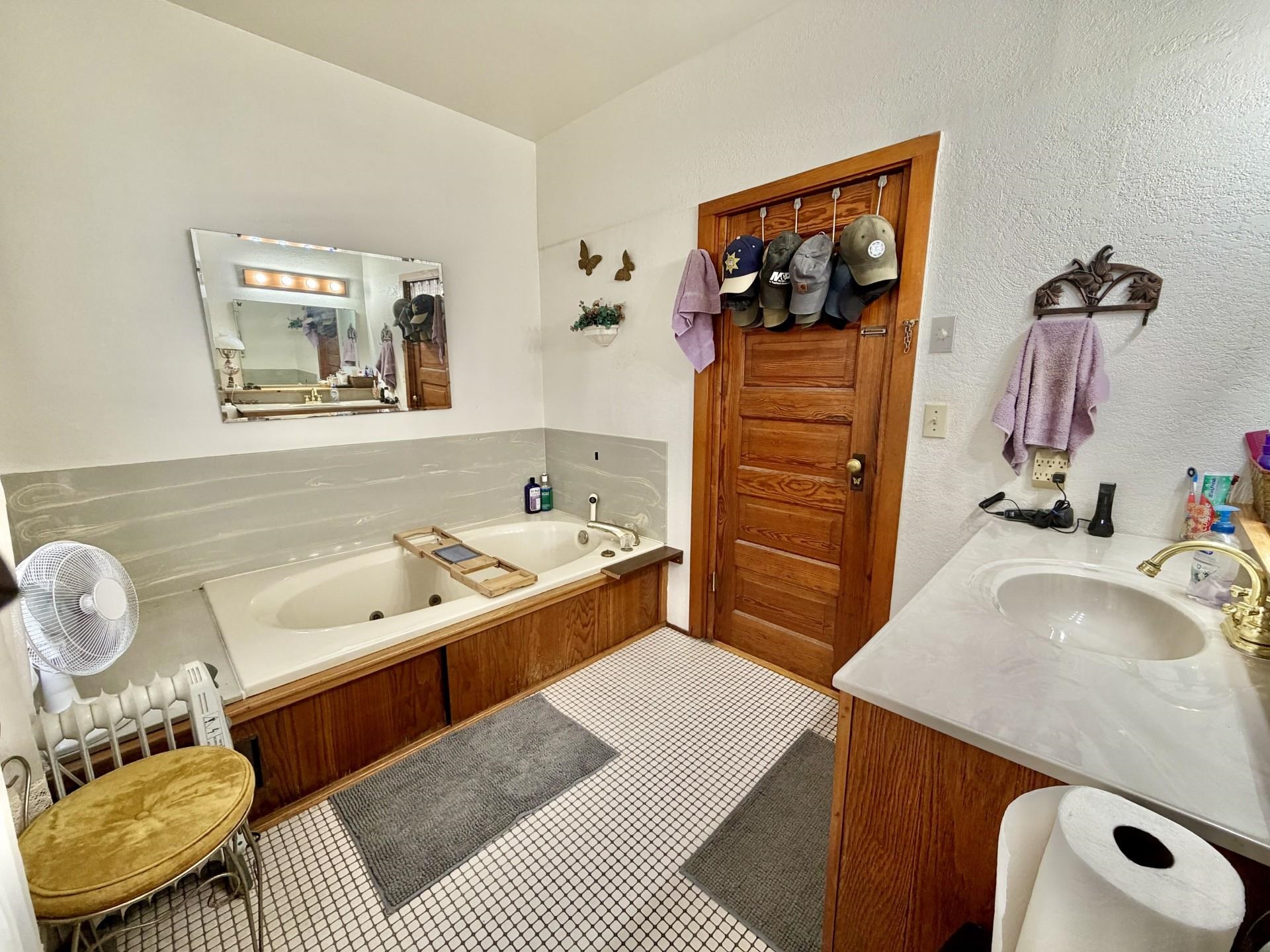 31 3rd Street Savanna, IL 61074 - Photo 9 of 42 a bathroom with a tub sink and mirror